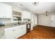 Well-lit kitchen showcasing white cabinetry, granite countertops, and stainless steel appliances at 401 Wyndham Drive, Fuquay Varina, NC 27526