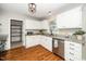 Updated kitchen featuring white cabinets, granite countertops, and stainless steel appliances at 401 Wyndham Drive, Fuquay Varina, NC 27526