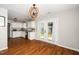 Bright kitchen with white cabinets, stainless steel appliances, and French doors leading to the backyard at 401 Wyndham Drive, Fuquay Varina, NC 27526