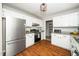 Kitchen features stainless steel appliances, white cabinets and granite countertops at 401 Wyndham Drive, Fuquay Varina, NC 27526