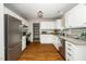 Spacious kitchen with stainless steel refrigerator, white cabinets, and granite countertops at 401 Wyndham Drive, Fuquay Varina, NC 27526