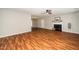 Spacious living room featuring wood floors, fireplace, ceiling fan, and natural light at 401 Wyndham Drive, Fuquay Varina, NC 27526