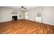 Open living room with hardwood floors, fireplace, and bright windows at 401 Wyndham Drive, Fuquay Varina, NC 27526