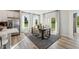 Bright dining room featuring wood floors, modern table set, and slider to the outdoor patio at 410 Gaston Park Ln # 200, Wake Forest, NC 27587