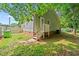 View of fenced backyard and a stairway leading to a side door at 413 Top Greene Ln, Raleigh, NC 27601
