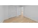 Bright bedroom featuring vinyl floors and a closet with paneled doors at 413 Top Greene Ln, Raleigh, NC 27601