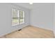 Well-lit bedroom with a large window providing natural light at 413 Top Greene Ln, Raleigh, NC 27601