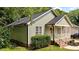 An exterior view of a charming home with light green siding and mature landscaping at 413 Top Greene Ln, Raleigh, NC 27601