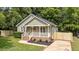 Charming home with a welcoming front porch and tasteful landscaping at 413 Top Greene Ln, Raleigh, NC 27601