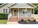 Charming front porch with brick steps, and a natural wood front door at 413 Top Greene Ln, Raleigh, NC 27601