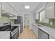 Modern kitchen featuring stainless steel appliances, white cabinets, and bright lighting at 413 Top Greene Ln, Raleigh, NC 27601