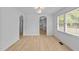 Bright living room featuring wood floors, arched doorways, and large windows at 413 Top Greene Ln, Raleigh, NC 27601