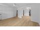 Bright living room with light wood flooring, ceiling fan, and arched doorways at 413 Top Greene Ln, Raleigh, NC 27601