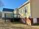 Rear view showing an elevated deck highlighting an outdoor living space with an ample backyard at 414 Ash Lily Ct, Nashville, NC 27856