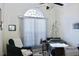 Bedroom with adjustable hospital bed, lounge chair, and large window with blinds at 414 Ash Lily Ct, Nashville, NC 27856