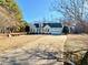 View of a charming one-story home with well-kept lawn and a long private driveway at 414 Ash Lily Ct, Nashville, NC 27856