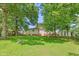 Spacious backyard featuring lush lawn, mature trees, and storage shed, creating a private outdoor retreat at 422 Hyde St, Burlington, NC 27217