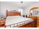 Spacious bedroom with a wooden bed frame, dresser, and a window with blinds at 422 Hyde St, Burlington, NC 27217