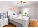 Bedroom with hardwood floors, a white bed frame, and natural light from a window at 422 Hyde St, Burlington, NC 27217