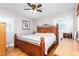 Bedroom featuring a wooden bed frame, hardwood floors, and a ceiling fan at 422 Hyde St, Burlington, NC 27217
