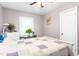 Bright bedroom with hardwood floors, a white bed frame, and a window with blinds at 422 Hyde St, Burlington, NC 27217
