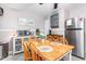 Charming dining area with a wooden table and stainless steel refrigerator at 422 Hyde St, Burlington, NC 27217