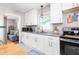 Modern kitchen with white cabinets and a view into the living area at 422 Hyde St, Burlington, NC 27217