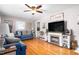 Cozy living room with hardwood floors and a fireplace featuring a ceiling fan at 422 Hyde St, Burlington, NC 27217