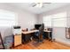 Home office with hardwood floors, two windows, and a black computer chair at a desk at 422 Hyde St, Burlington, NC 27217