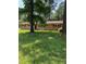 Charming brick ranch-style home with a lush green lawn and mature shade trees at 4618 Blanchard Rd, Durham, NC 27713