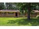 Inviting brick home with red shutters, black front door, and well-manicured lawn at 4618 Blanchard Rd, Durham, NC 27713
