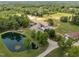 Aerial view of home with lush trees, long driveway, and a serene pond and service buildings at 4659 Antioch Rd, Oxford, NC 27565