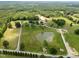 Expansive property featuring lush greenery, multiple ponds, and a mix of residential and commercial structures at 4659 Antioch Rd, Oxford, NC 27565