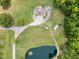 Areal view of home and acreage, featuring a large lawn, private pond, outbuildings and parking at 4659 Antioch Rd, Oxford, NC 27565