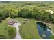 Aerial view of home with lush trees, long driveway, and a serene pond at 4659 Antioch Rd, Oxford, NC 27565