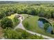 Aerial view of log home, pond, acreage, and winding driveway at 4659 Antioch Rd, Oxford, NC 27565