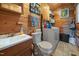 Compact bathroom and laundry room featuring a sink, toilet, and stacked washer/dryer at 4659 Antioch Rd, Oxford, NC 27565
