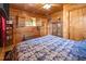Bedroom showcasing beautiful wood paneling and a cozy atmosphere with comfortable bedding and rustic decor at 4659 Antioch Rd, Oxford, NC 27565