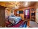 Cozy bedroom featuring wood-paneled walls, ceiling fan, patterned rug, and comfortable furnishings at 4659 Antioch Rd, Oxford, NC 27565