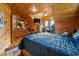 Wood paneled bedroom with slanted ceiling, TV, comfortable bedding, desk and workspace at 4659 Antioch Rd, Oxford, NC 27565