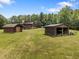 Beautiful log cabin home with outbuildings, sheds, and a luscious lawn at 4659 Antioch Rd, Oxford, NC 27565