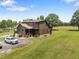 Stunning log cabin home with an attached two car garage surrounded by well-manicured lawn and trees at 4659 Antioch Rd, Oxford, NC 27565