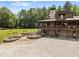 Beautiful log cabin home with an attached two car garage surrounded by trees at 4659 Antioch Rd, Oxford, NC 27565