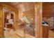 Hallway featuring wood paneling, with staircase and view to living area at 4659 Antioch Rd, Oxford, NC 27565