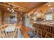 Open-concept kitchen with wood-beamed ceiling, stone accent wall, wooden cabinets, and seating at the island at 4659 Antioch Rd, Oxford, NC 27565