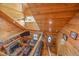 Open-concept living room with wood paneling, stone fireplace, stairs, and comfortable seating at 4659 Antioch Rd, Oxford, NC 27565