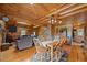 Living room and dining area showcasing hardwood floors, stone fireplace, and cozy furniture at 4659 Antioch Rd, Oxford, NC 27565