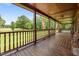 Covered wooden porch with American flags and a view of the grounds at 4659 Antioch Rd, Oxford, NC 27565