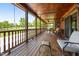 Spacious covered wooden porch with furniture and a porch swing at 4659 Antioch Rd, Oxford, NC 27565