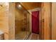 Modern shower with glass door and walls, along with wood paneling, and tile floors at 4659 Antioch Rd, Oxford, NC 27565